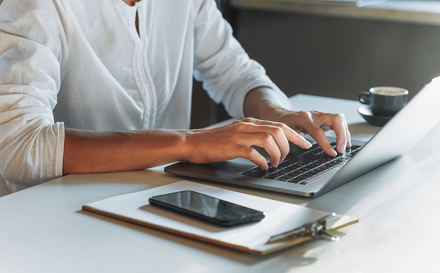 closeup of someone's hands typing on computer