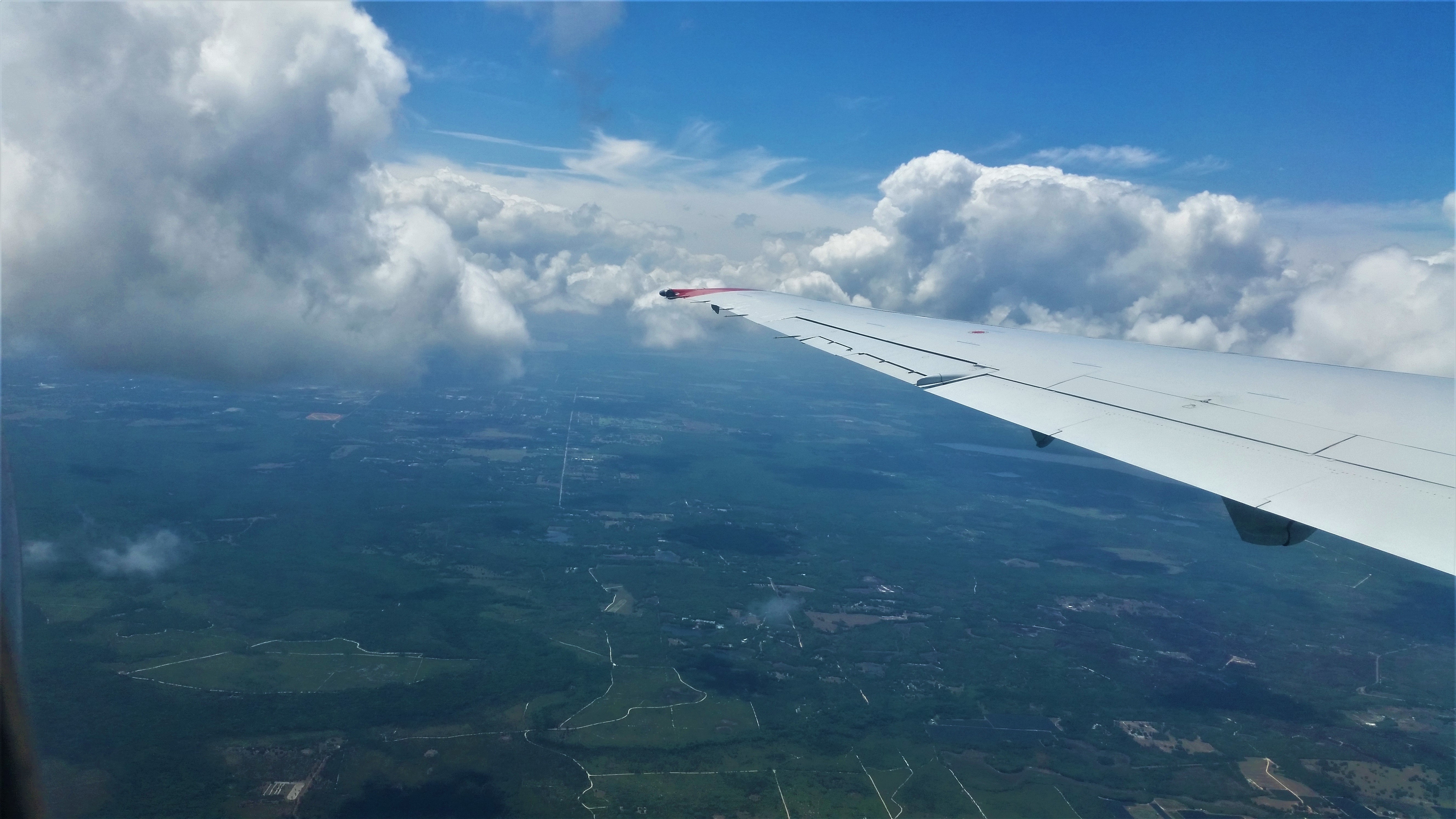 clouds surrounding the wing of a plane.