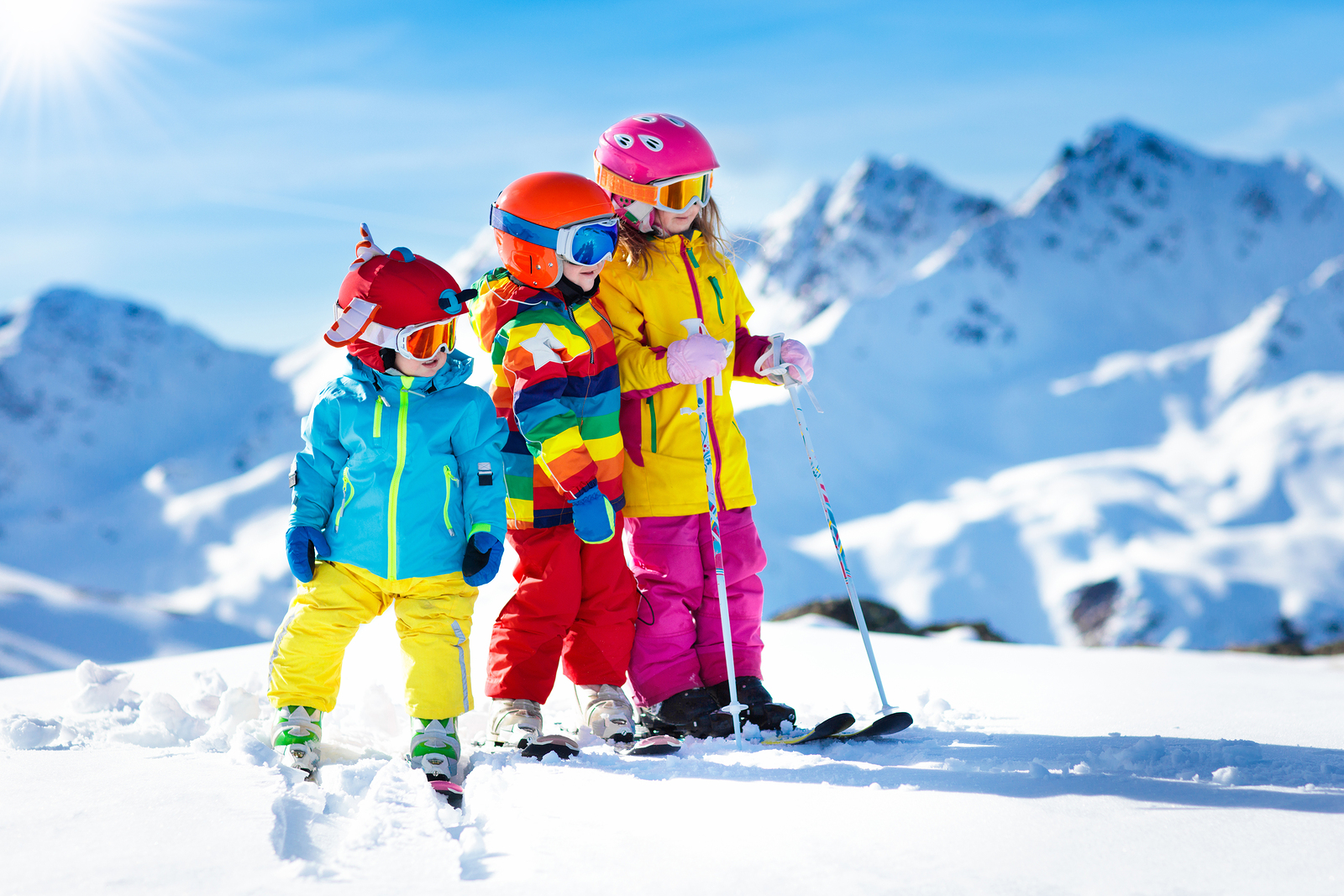 kids brightly dress in ski clothes