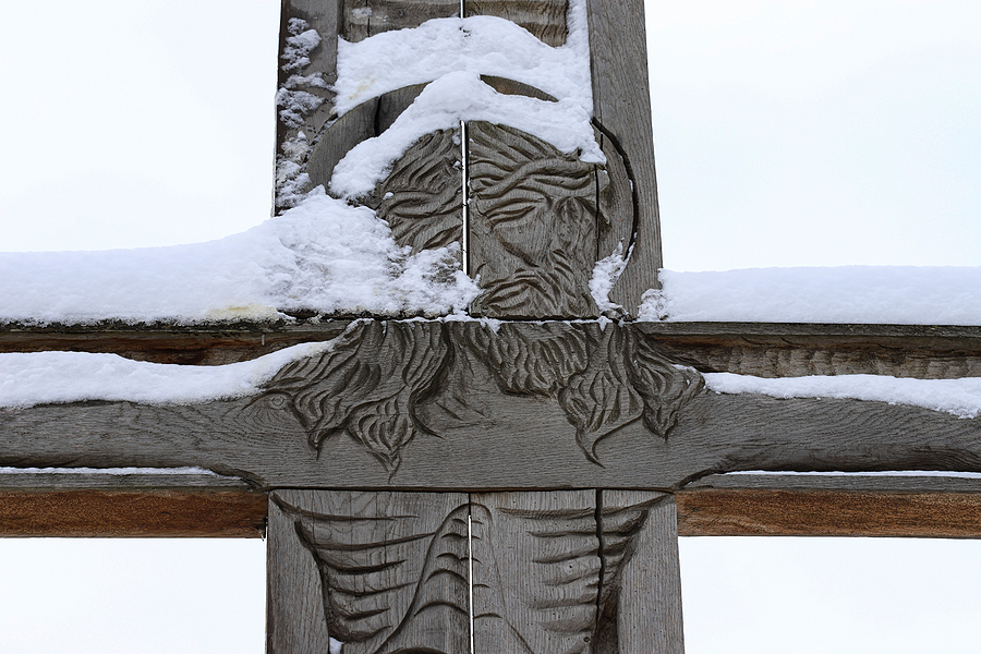 Imprint of Jesus on snowy wooden cross